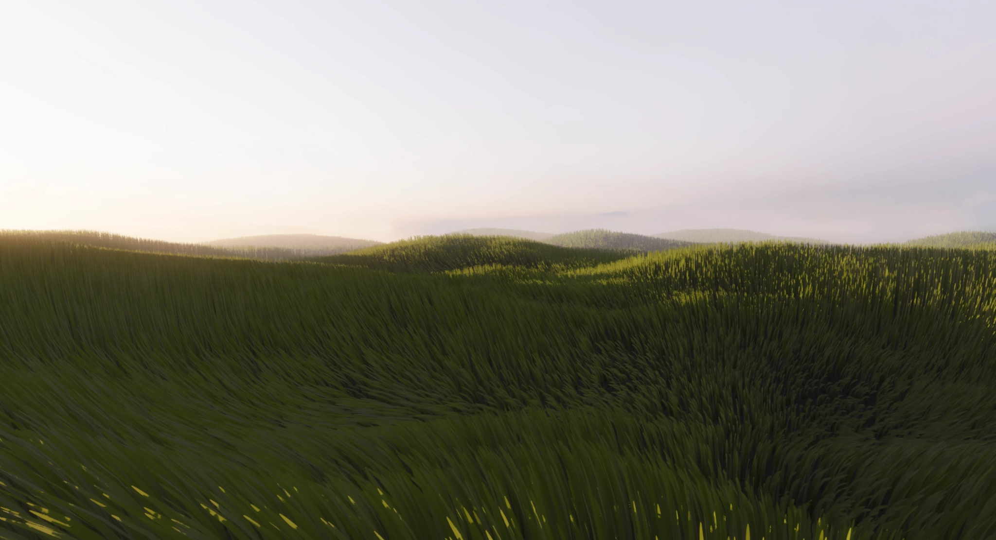 The meadow at dusk, the grass darkening green, mist on the hills under a rose-grey sky